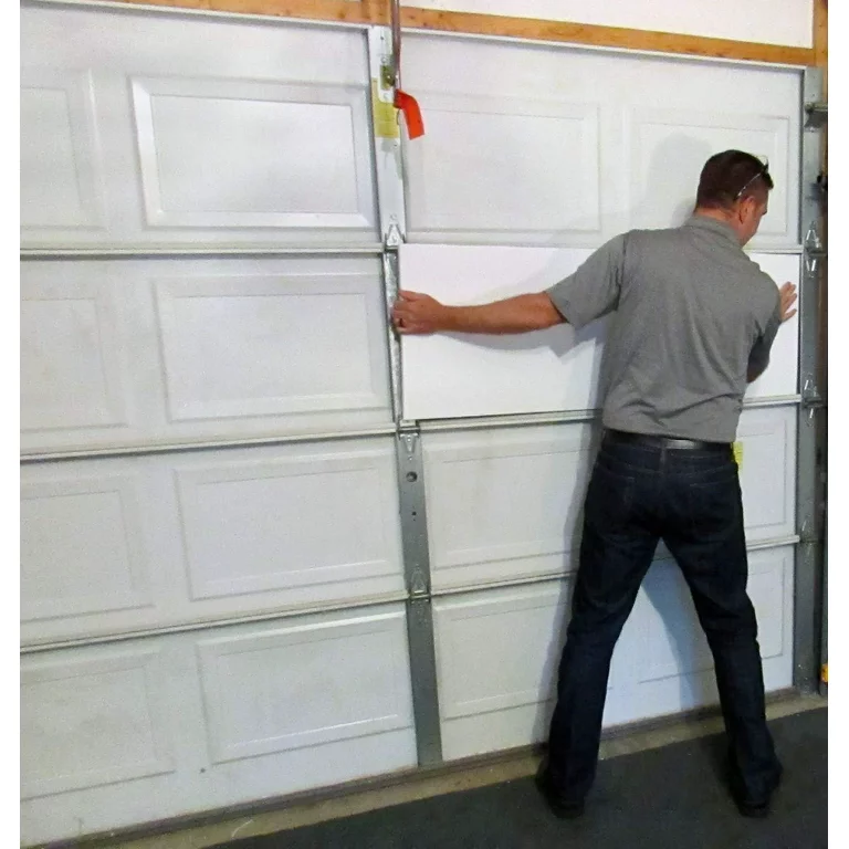 Man installing garage door insulation