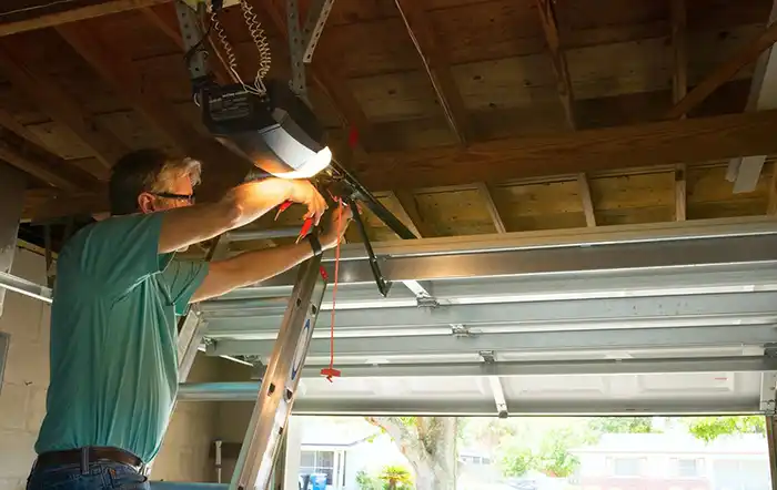 Technician doing garage door maintenance
